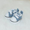 A pair of light blue casual sneakers with white laces and soles resting on a white surface.