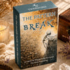 A box of The Pattern Break oracle card deck with a textured gold and brown design resting on a light fabric.
