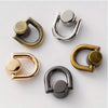 A collection of D-shaped metal bag handles in gold, silver, and bronze finishes.