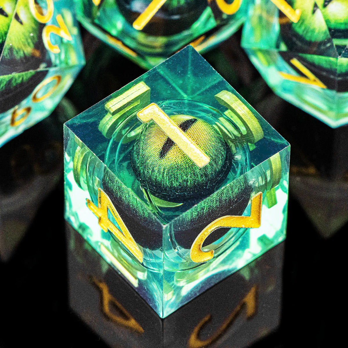 A close-up view of a green resin dice set, featuring a polyhedral die with a gold number and an eye design.