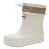 A white waterproof rain boot with a tan cuff and a small red and yellow brand tag.