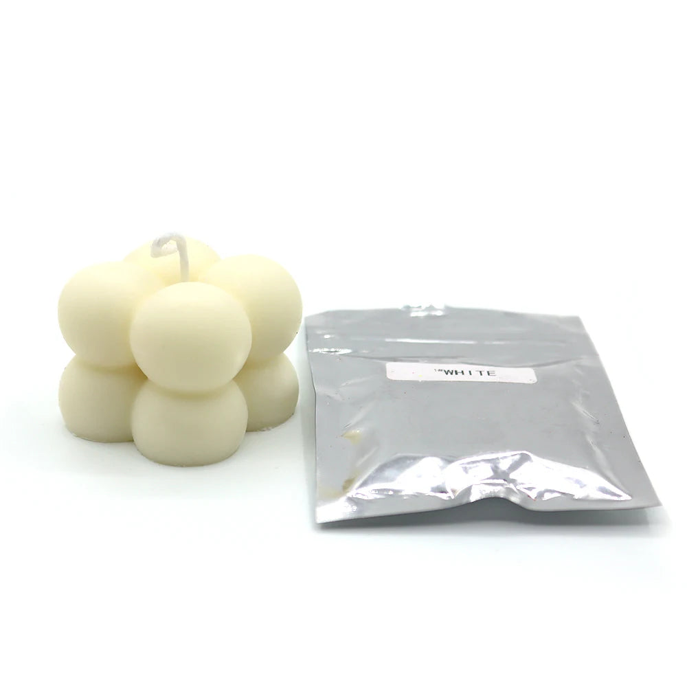 A small white plastic bag containing candle dye chips for soy wax, beeswax, and paraffin.