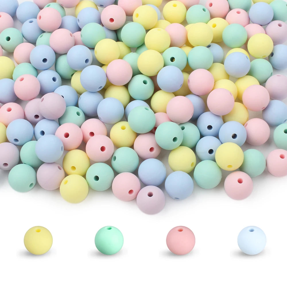 A mix of round, flexible silicone beads in various pastel colors including pink, yellow, green, and blue.