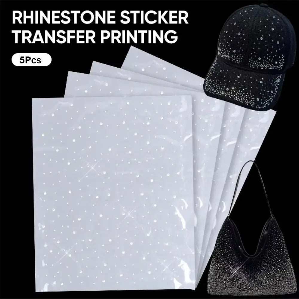 A set of five white rhinestone sticker transfer printing sheets next to a black baseball cap.