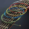 A close-up view of six colored acoustic guitar strings arranged on a wooden fretboard.