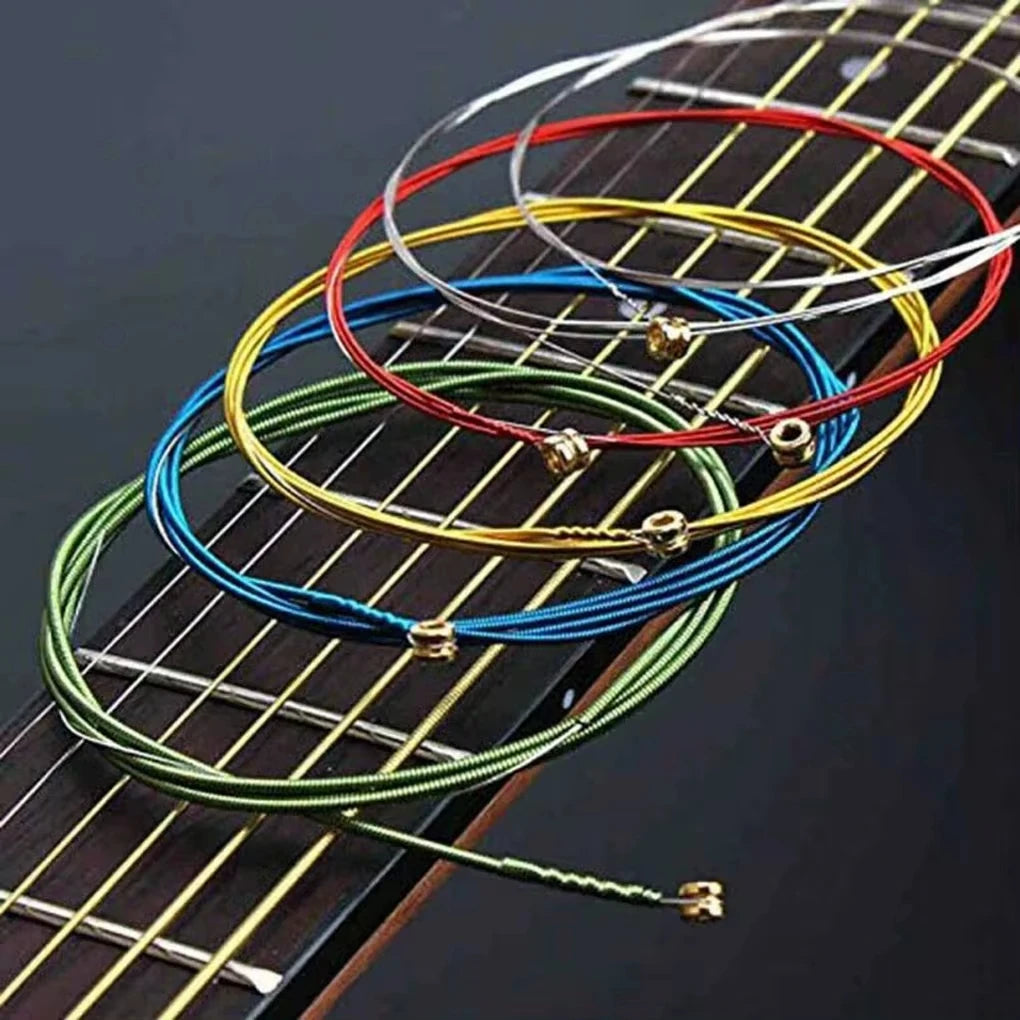 A close-up view of six colored acoustic guitar strings arranged on a wooden fretboard.