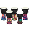 A set of four colorful hand drums or djembes with black bodies and white heads, featuring traditional patterns.