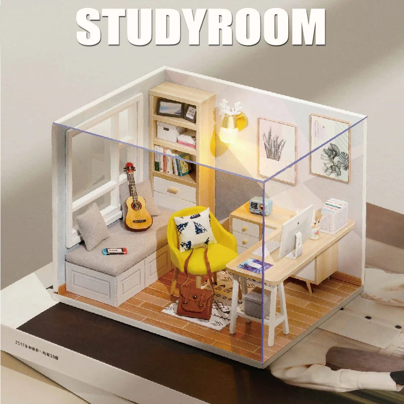 A wooden miniature dollhouse kit setup showing a study room interior with shelves, a desk, and a yellow chair.