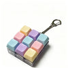 A clear plastic container holds colorful fidget keychain stress relievers with silver clasps.