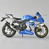 Blue and silver Suzuki GSX-R1000R diecast motorcycle model in a studio setting.