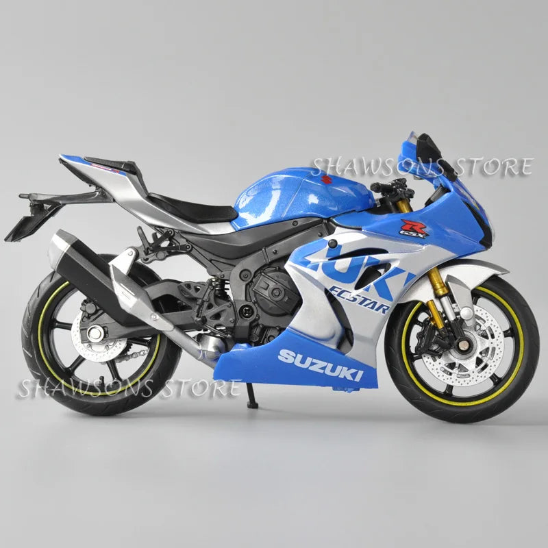 Blue and silver Suzuki GSX-R1000R diecast motorcycle model in a studio setting.