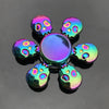 A colorful metal fidget spinner featuring a central disc and eight surrounding skull-shaped pieces.