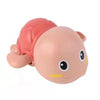 A pink wind-up swimming duck bath toy for toddlers with a pink shell and yellow accents.