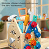A wooden busy house toolbox for children featuring various tools and shape matching elements.