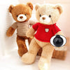 Two brown teddy bears with black safety eyes, one wearing a red shirt.