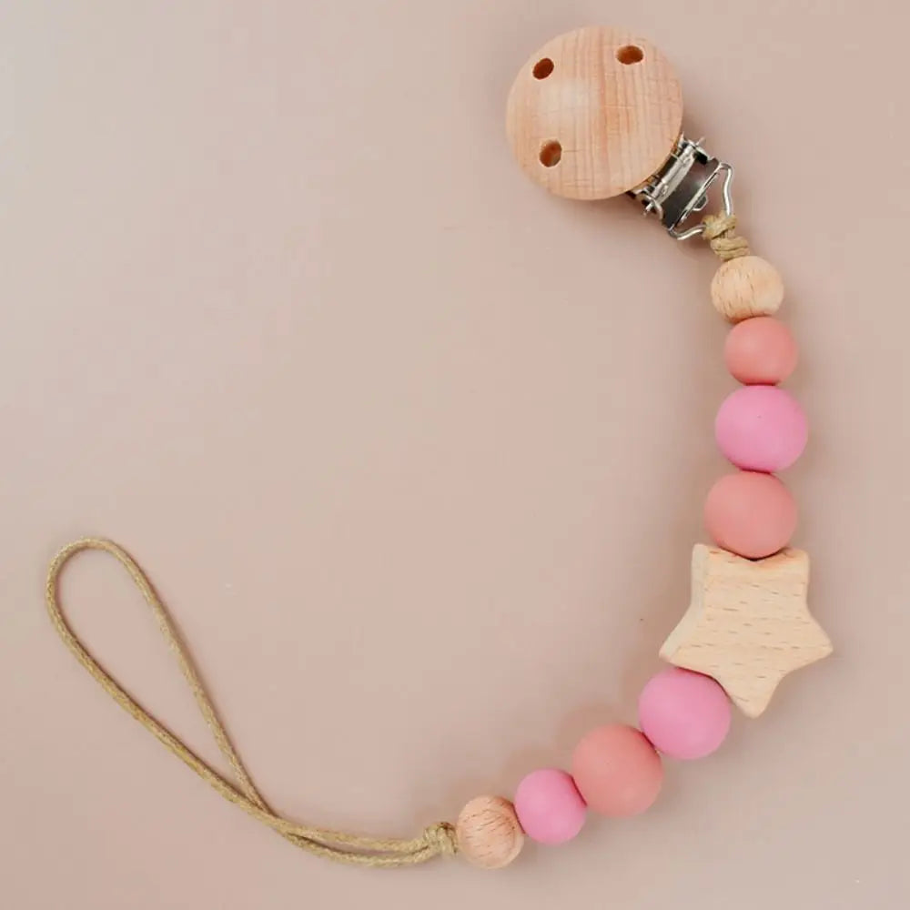 A wooden pacifier clip featuring silicone beads and a star-shaped piece, attached to a cord.