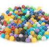 A pile of colorful rhinestone acrylic beads in various shades including red, green, blue, yellow, and black.