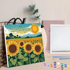 A framed paint by numbers kit featuring a vibrant sunflower field and sky scene.