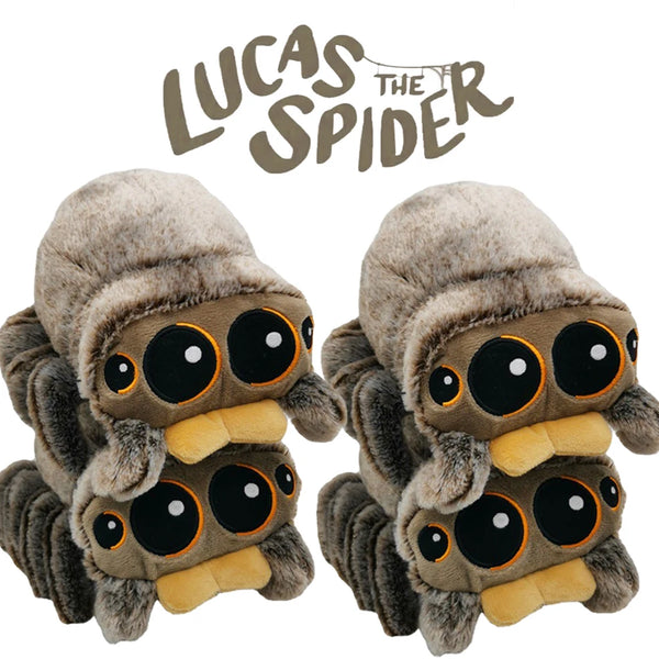 A pair of soft, gray plush toys resembling spiders with large black eyes and yellow accents.