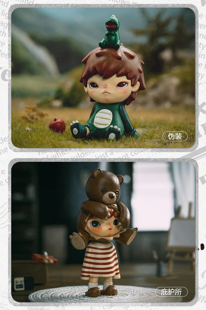 A small mischievous figure with brown hair and green skin sits on grass, displayed next to a teddy bear figure.