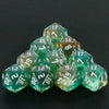 A pyramid of ten glittery green D20 dice with various numbers and colors for tabletop gaming.