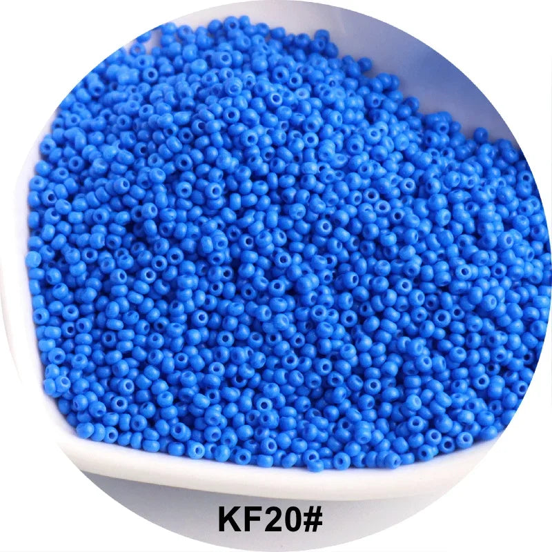 A pile of bright blue 1.5mm solid glass seed beads labeled KF20# for jewelry and craft.