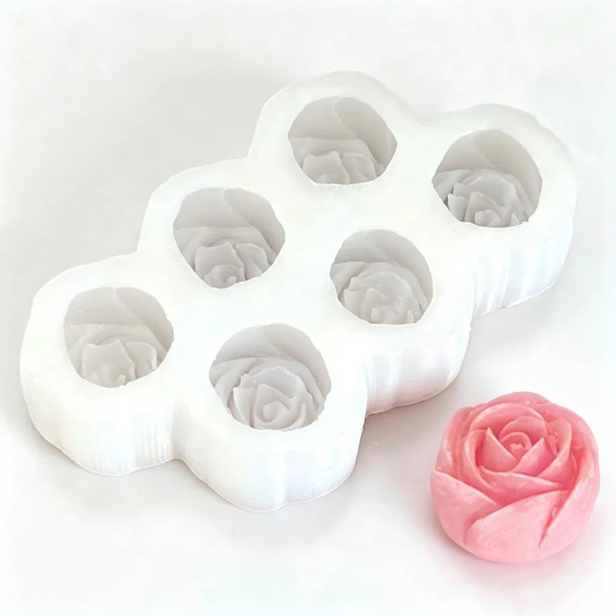 A white silicone mold set shaped like a flower with multiple small depressions for making candles, soap, or chocolate.