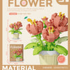A set of plastic flower blocks in pink and green colors used to build a model bouquet
