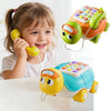 A young girl is holding a yellow phone toy and a green turtle toy, demonstrating the musical crawling turtle product.