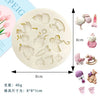A set of silicone baby-themed cake molds including a stroller, bottle, pacifier, and other accessories.