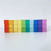 A row of colorful rainbow acrylic building blocks arranged horizontally.