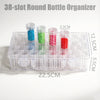 A clear plastic bottle organizer with 38 slots holds colored dot pens for diamond painting.