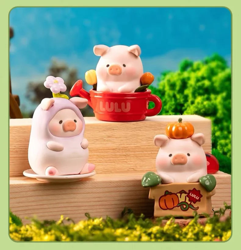 A collection of Lulu the Piggy Garden series figurines featuring pink and orange pigs in various poses and a red mug.