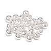 A cluster of small, silver-toned imitation pearl beads for DIY jewelry making.