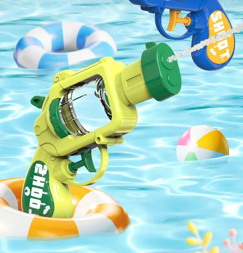 A yellow mini water blaster pistol is spraying water toward a floating inflatable ring and a ball in blue water.