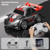 A black drift RC car with a red body and racing decals is shown next to its remote control and color box.