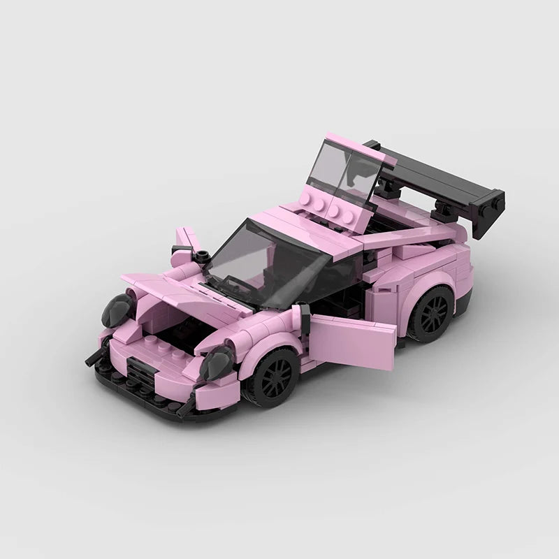 A pink classic rally car building block set with a raised hood and open cockpit.