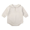 A cream-colored knit sweater and pants set for a toddler, featuring a round neck and zipper closure.