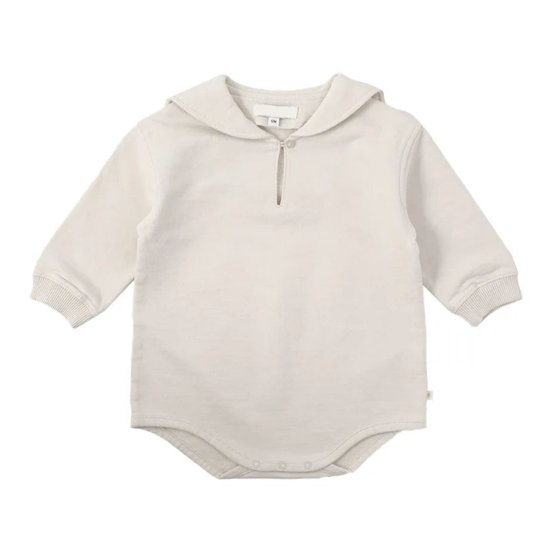 A cream-colored knit sweater and pants set for a toddler, featuring a round neck and zipper closure.