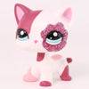 A pink and white shorthair cat bobble head figurine with sparkly purple eyes and pink accents.