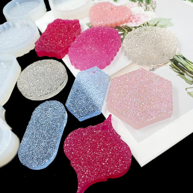 A collection of flexible silicone resin molds in various colors and shapes including heart, round, oval, and rectangle forms.