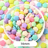 A bowl filled with pastel bear-shaped acrylic craft beads in various shades of pink, yellow, green, and purple.