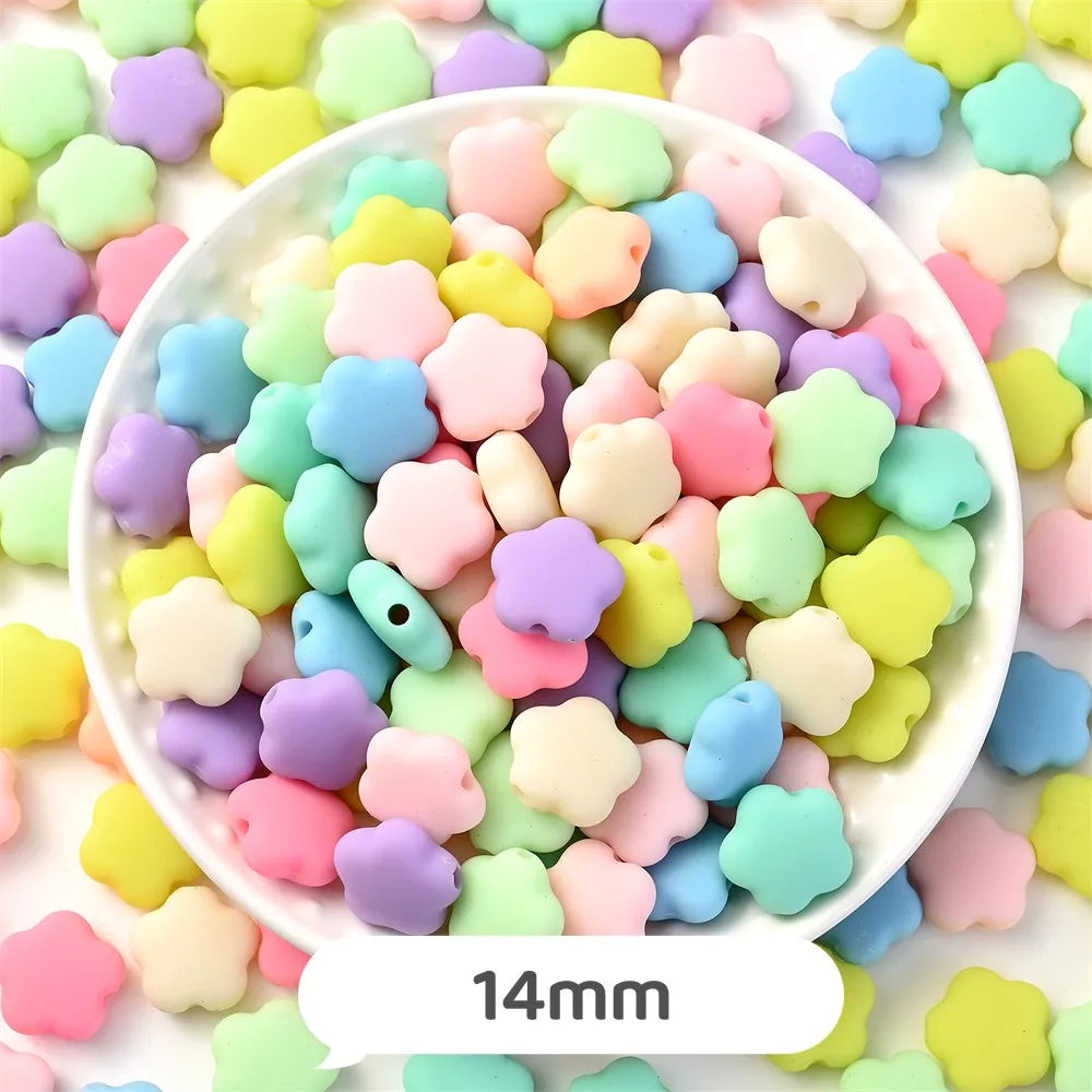 A bowl filled with pastel bear-shaped acrylic craft beads in various shades of pink, yellow, green, and purple.