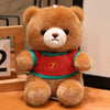 A fluffy brown teddy bear wearing a red and green football jersey with the number 7.