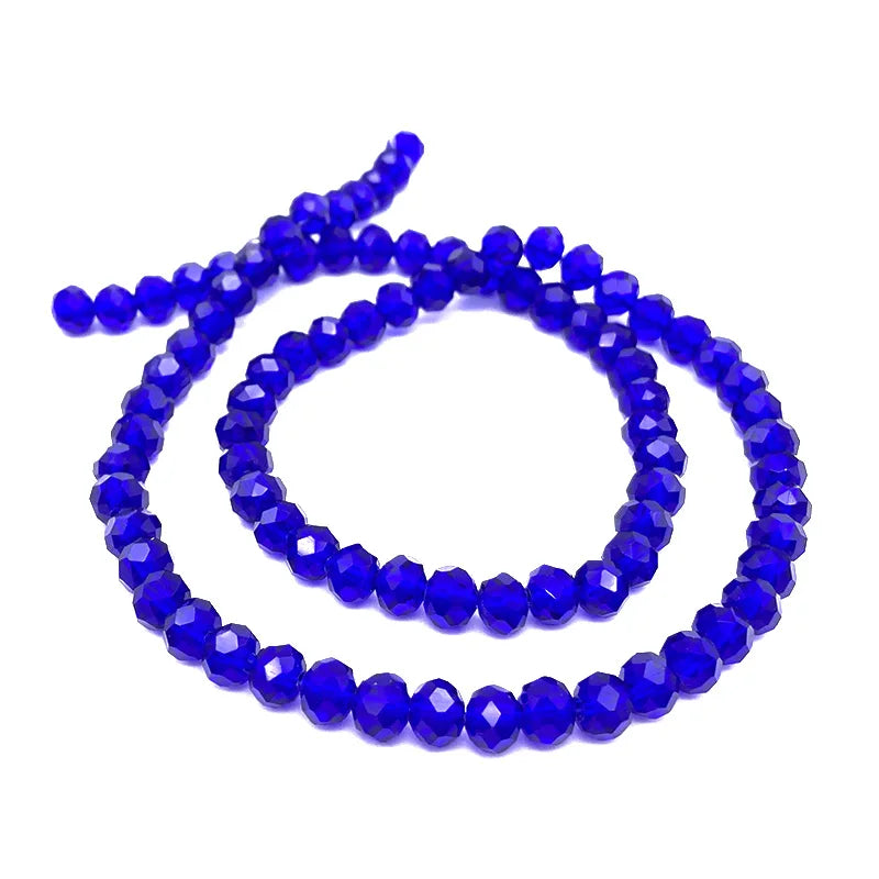A strand of deep blue faceted crystal beads used for jewelry making