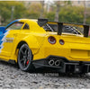 Yellow 1:24 scale diecast GTR sports car model with lights and sound on a gray asphalt surface.