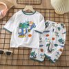 White long sleeve cotton pajama set for kids featuring a dinosaur graphic and matching pants