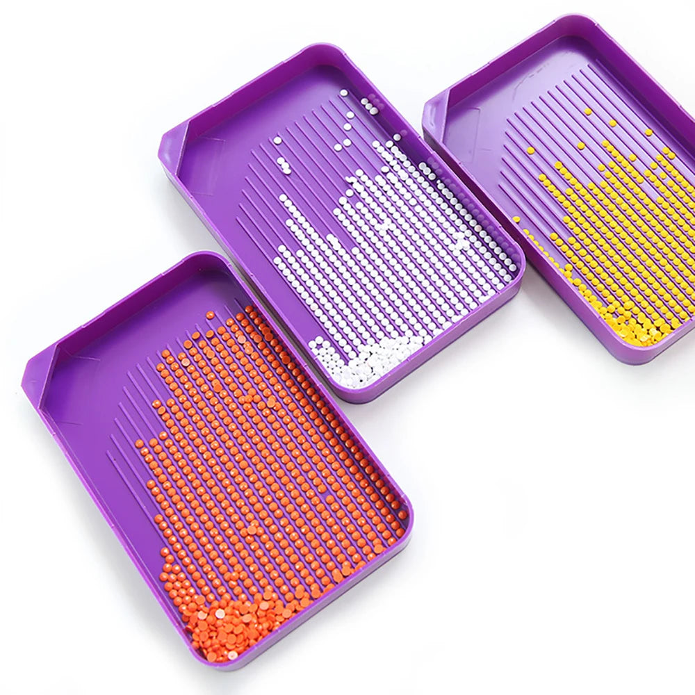 Purple diamond painting organizer kit with trays filled with colored dotting pens
