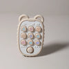 A light beige phone-shaped silicone teether with various buttons and features for babies.