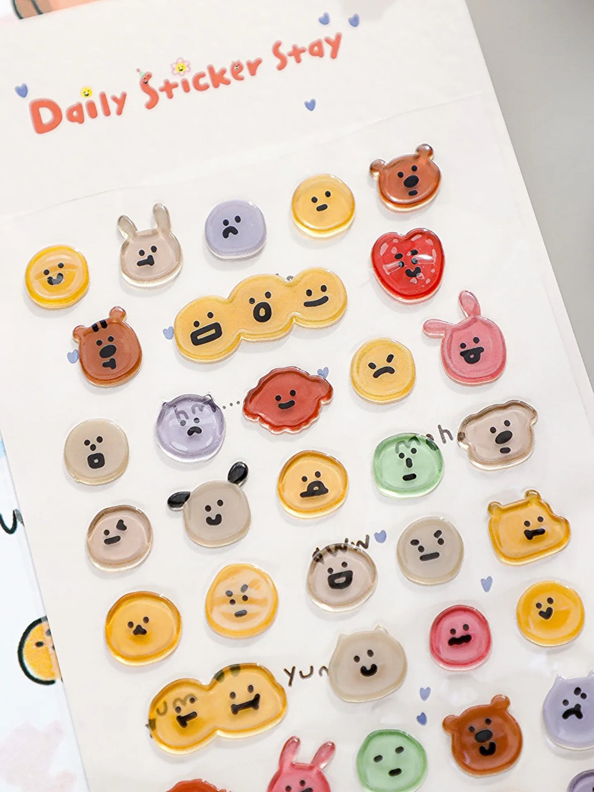 A collection of various 3D smile face crystal stickers in different colors and shapes for crafting